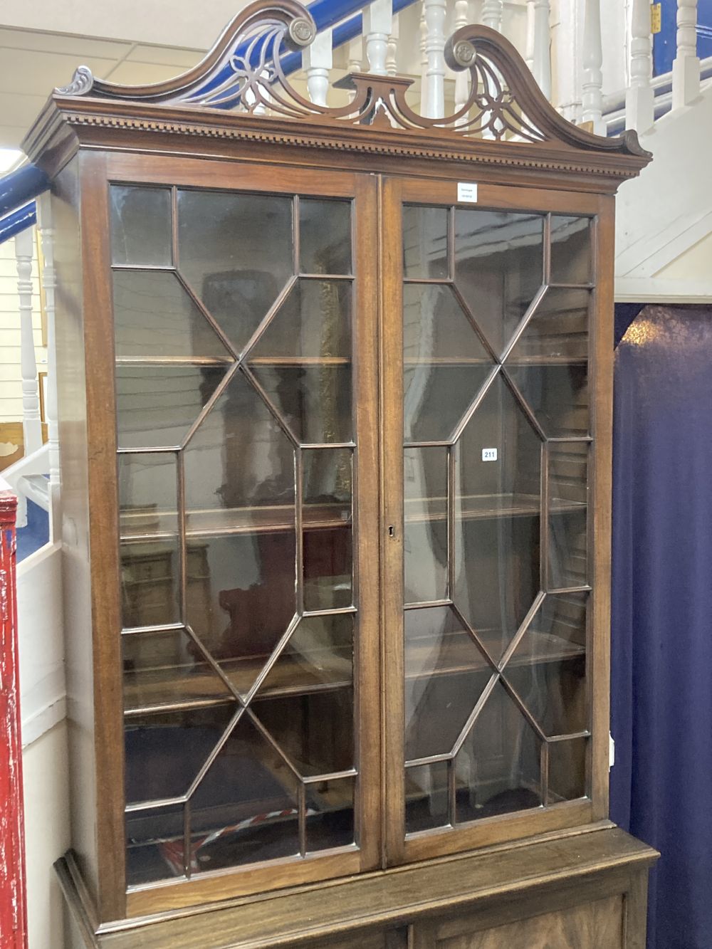 A George III style mahogany two door glass china display cabinet, with two panelled doors beneath, width 110cm depth 47cm height 220cm